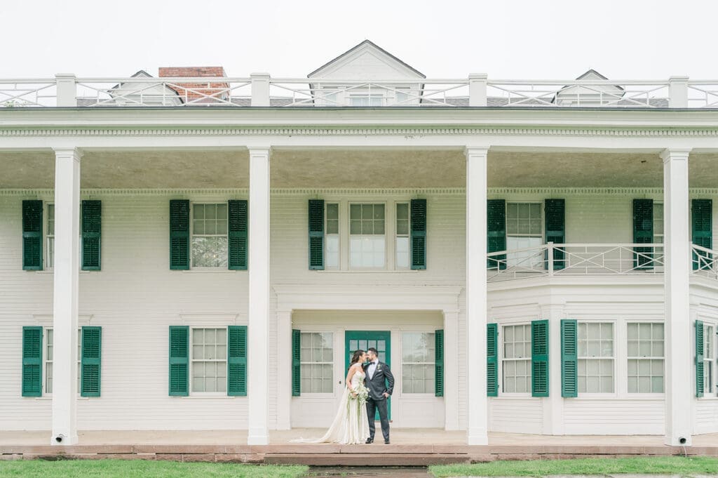 A couple kissing underneath the European-inspired Hill-Stead Museum in CT. 