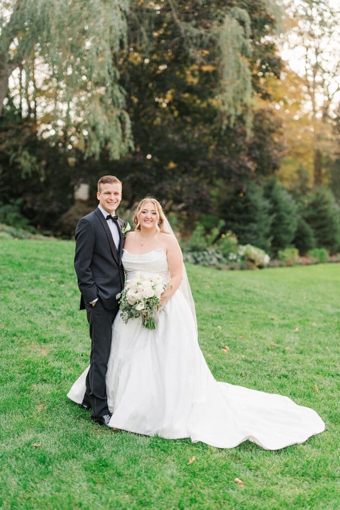 Trey and Magdalene smile for a classic portrait at their woodwinds wedding