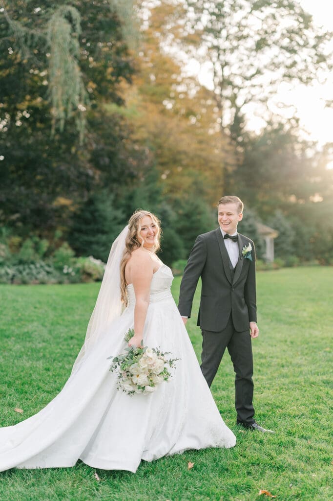 Trey and Magdalene smile for a classic portrait at their woodwinds wedding
