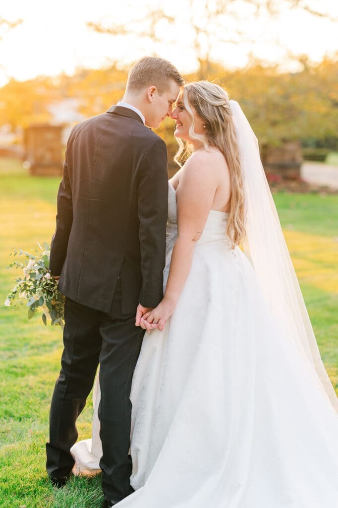 Trey and Magdalene nuzzle noses at their woodwinds wedding