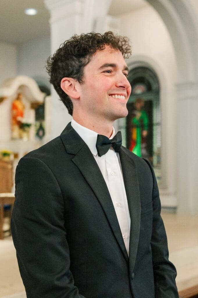 Mitch smiles as Miranda walks down the aisle. 
