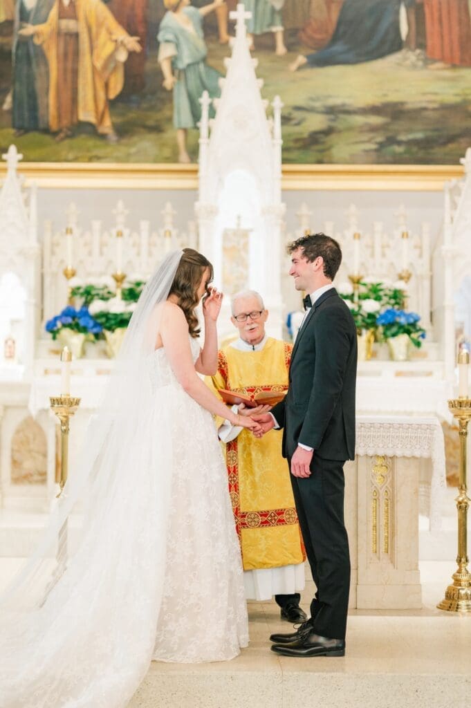 Miranda and Mitch hold hands during their ceremony. 