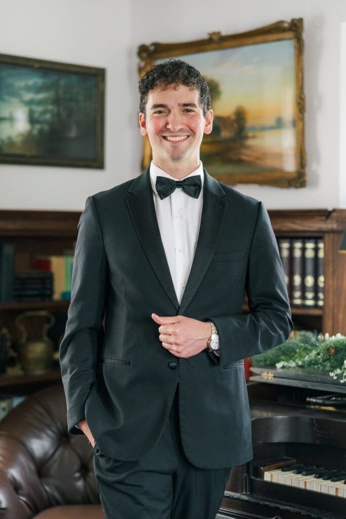 Mitch smiling in the library at his Aldworth Manor wedding. 
