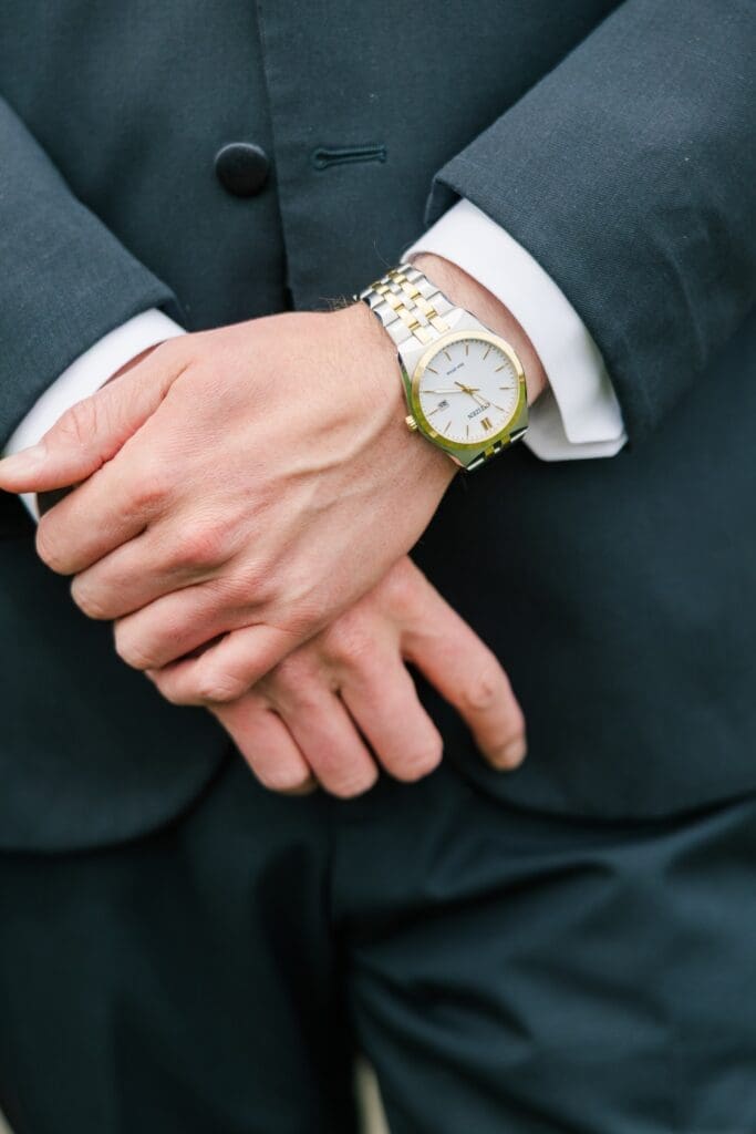 The groom's watch on his wrist. 