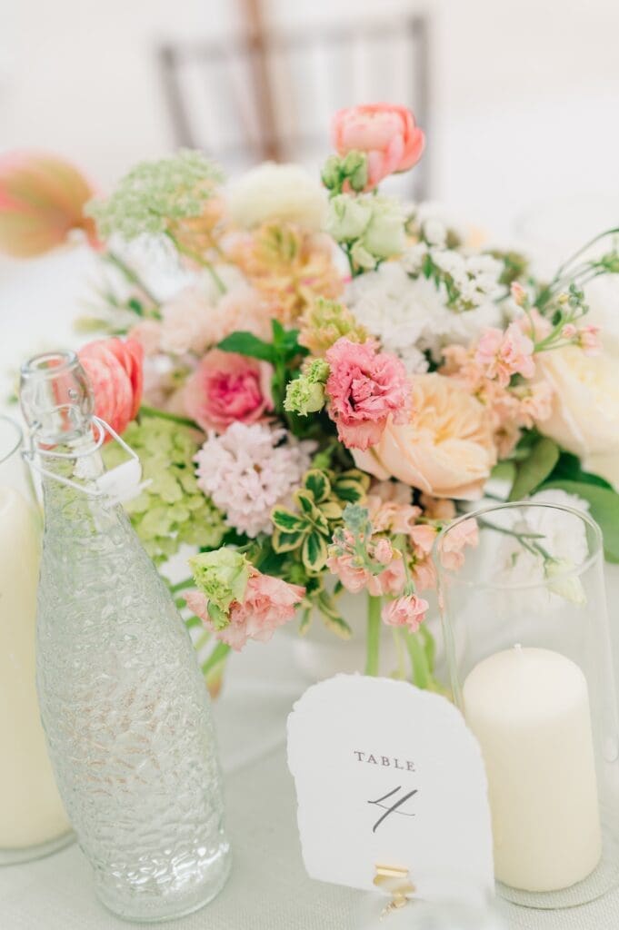 A pink and white floral arrangement at table 4