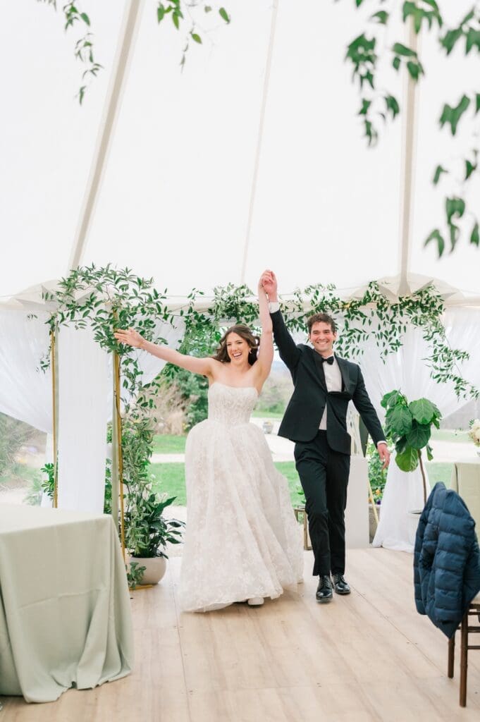 Mitch and Miranda cheer as they enter their wedding reception. 