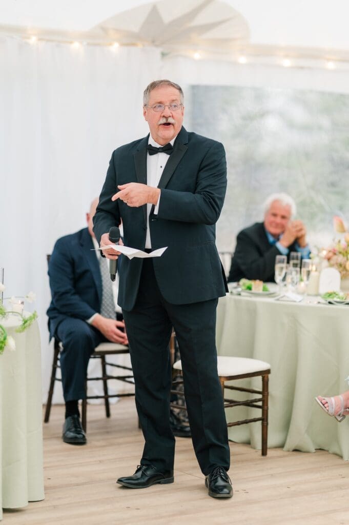 The bride's dad gives a speech. 