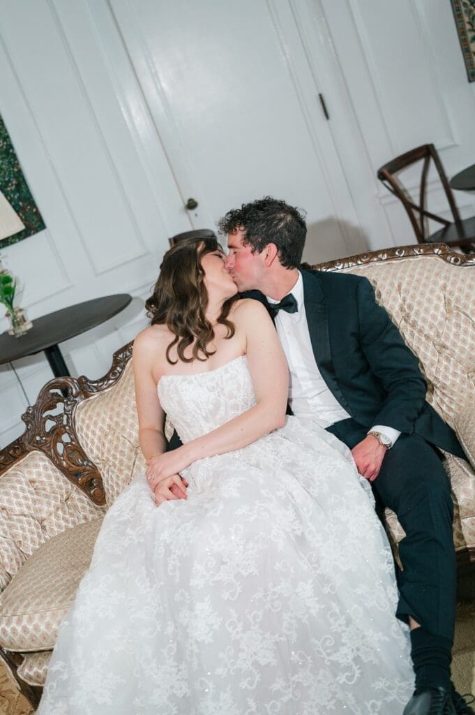 Mitch and Miranda kiss on the couch in the oval room. 