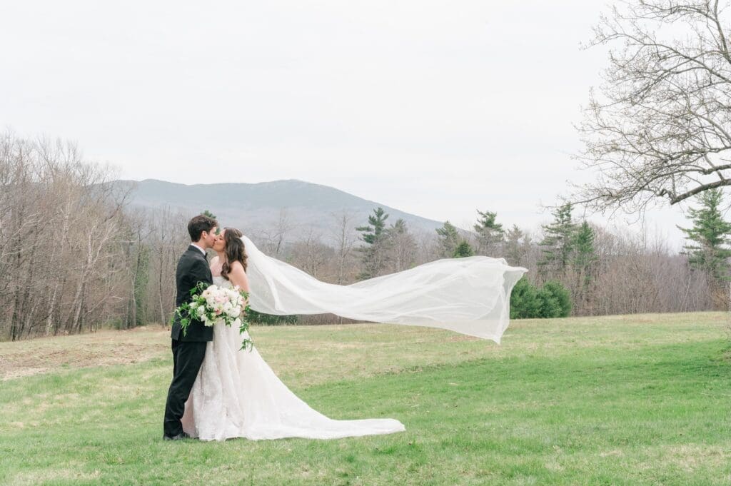 Miranda and Mitch kiss in front of the mountain at Aldworth Manor for a wedding portrait. 