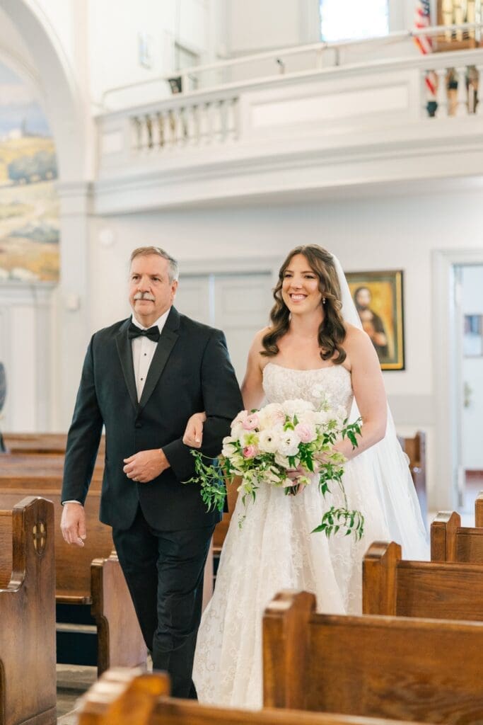 Miranda walks down the aisle with her dad. 