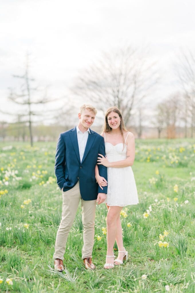 Sydney and Dylan stand with daffodils for photos. 