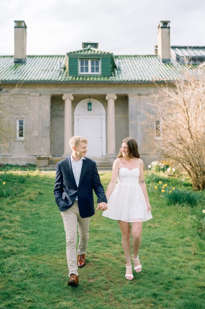 Sydney and Dylan hold hands as they walk along a pathway at Harkness Memorial State Park. 