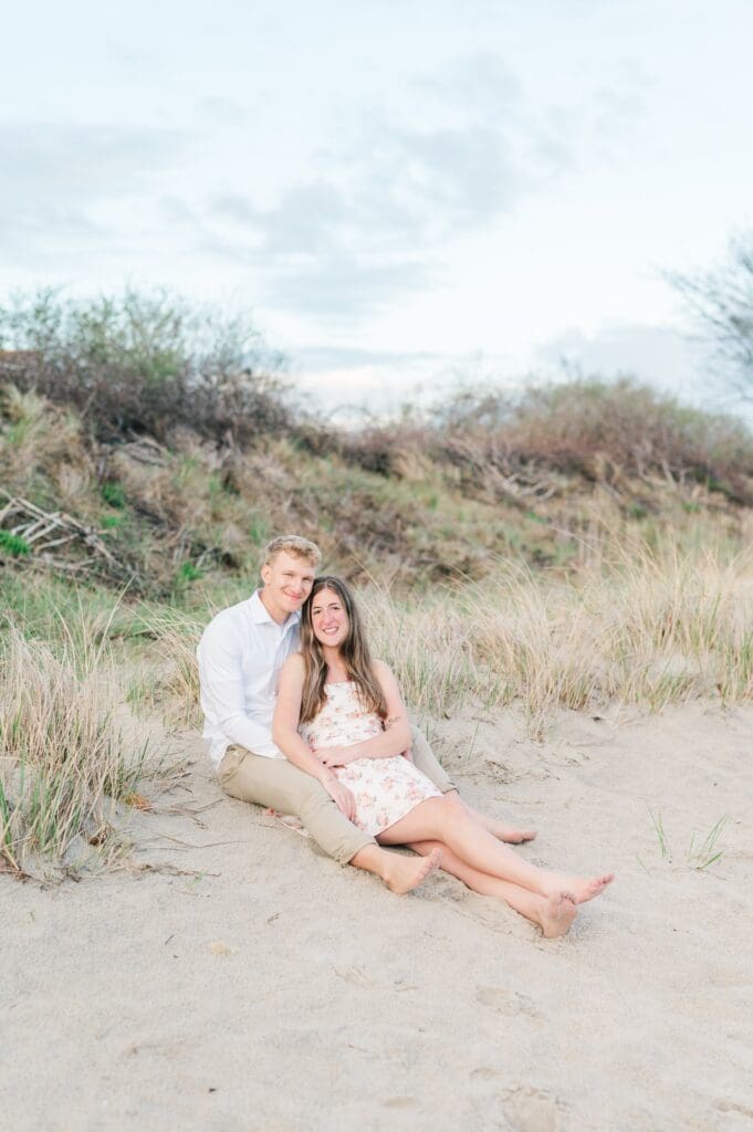 Syd and Dylan sit with one another at the beach in Harkness Memorial State Park. 
