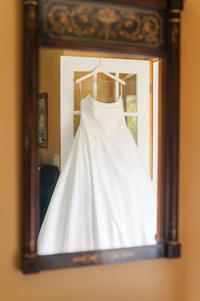 A wedding dress reflected in the mirror. 