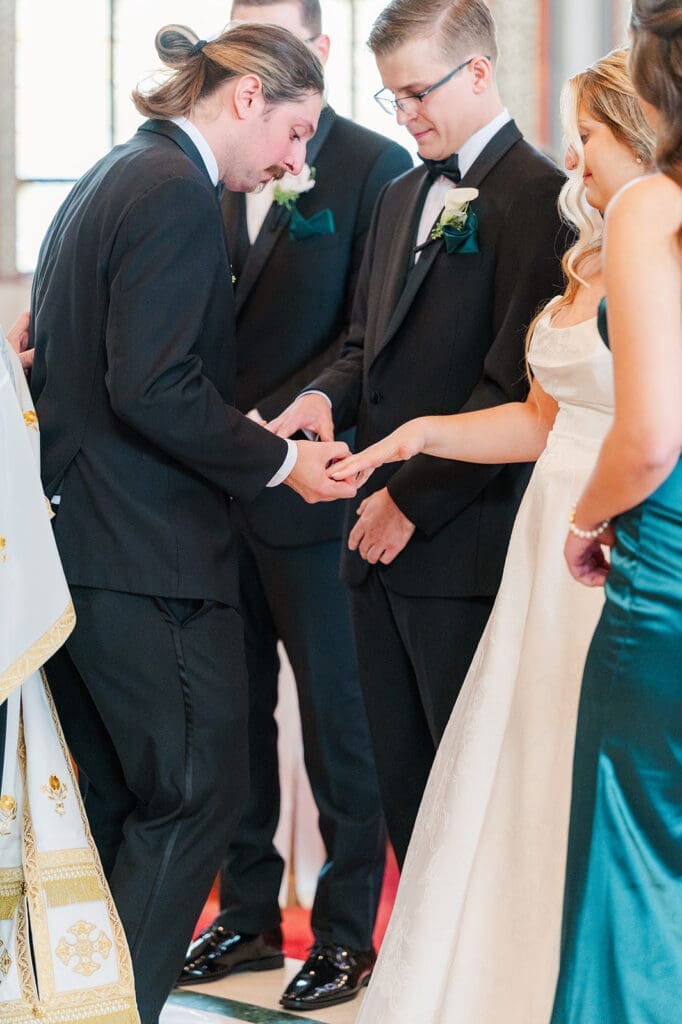 The rings are placed on the hands of Magdalene and Trey. 