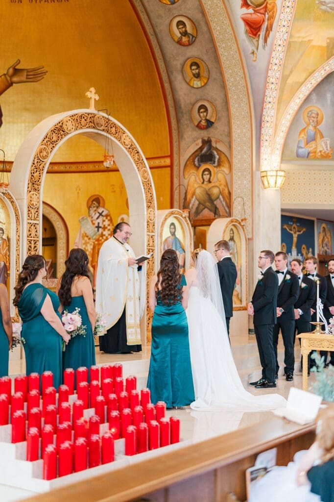 Fr. Peter prays over Magdalene and Trey. 
