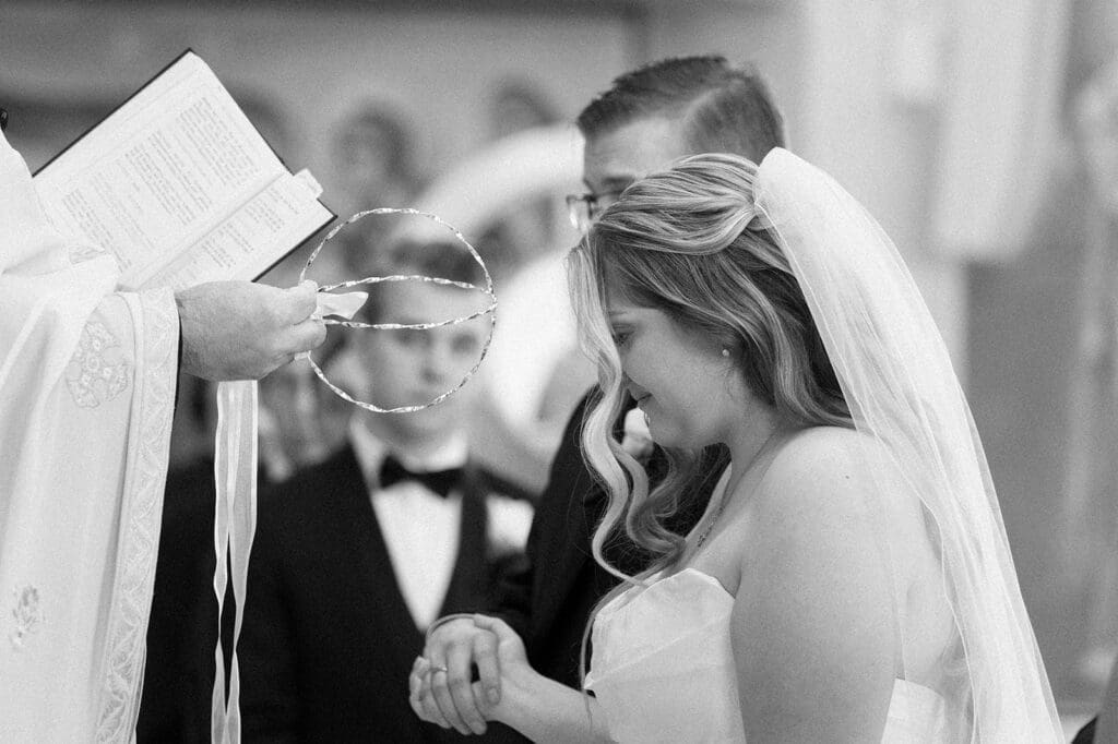 The crowns are blessed and placed on Magdalene and Trey's heads. 