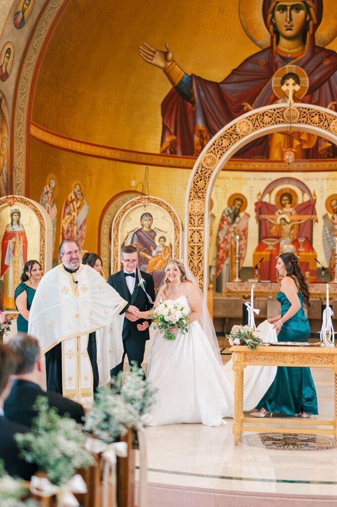 Fr. Peter leads Trey and Magdalene around the altar table. 