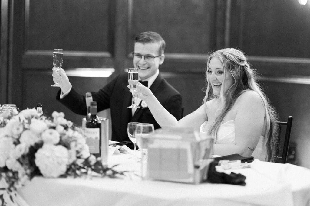 Magdalene and Trey cheers glasses with one another