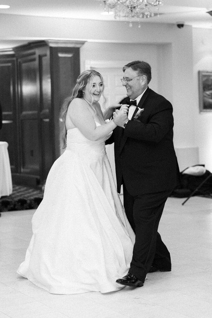 Magdalene and her father dance with one another at Woodwinds