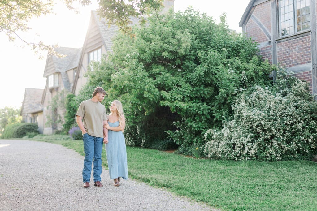 Lois and George walk together at Topsmead State Park for their engagement photos