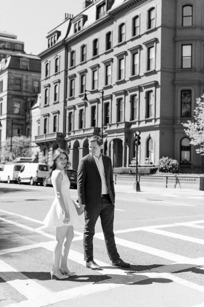 Julia and Brandon walk across a crosswalk in Boston. 