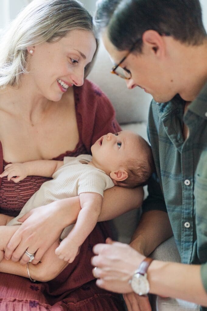 Baby G looks up at mom and dad and smiles at them. 