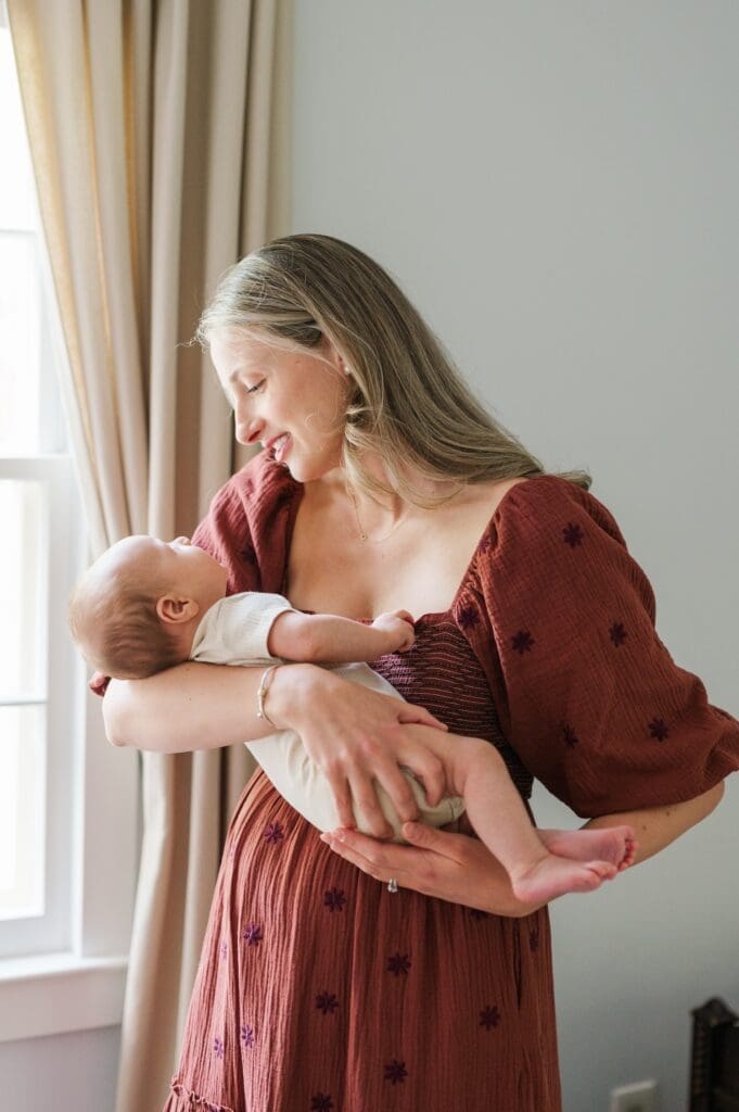 Mom holds baby G near the windowsill in their Fairfield, CT home. 
