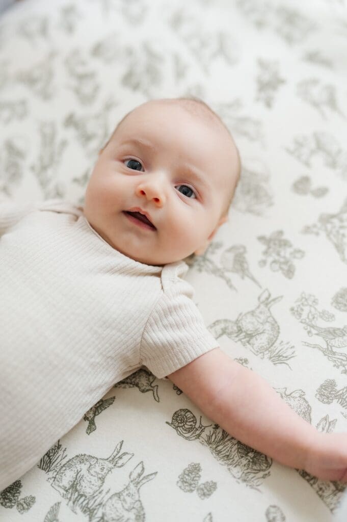 Baby G lays down and smiles. 