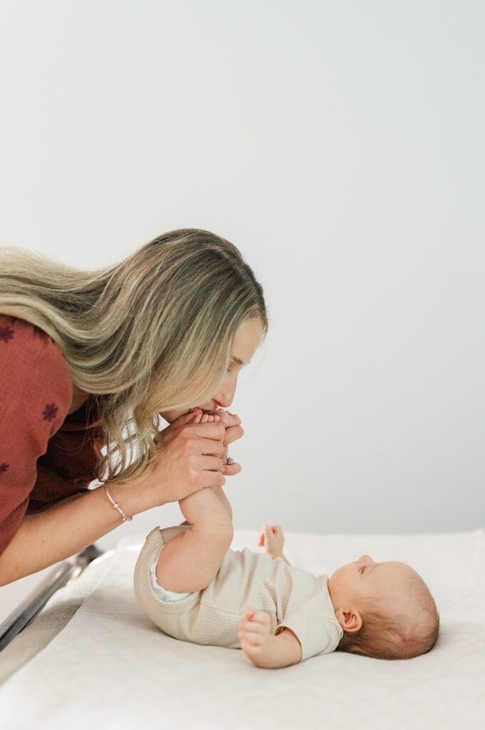 Mom kisses baby g's toes