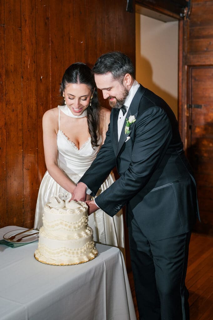 Natalie and Tom cut their wedding cake. 