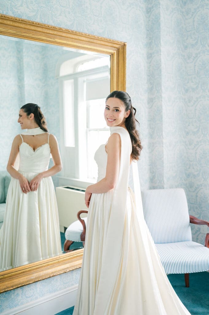 Natalie smiles over her shoulder at the Simsbury 1820 Inn. 