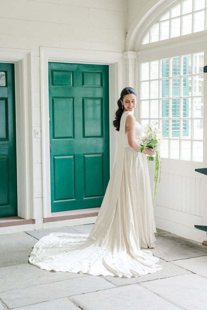 Natalie smiles in her wedding dress at the Hill-Stead Museum. 