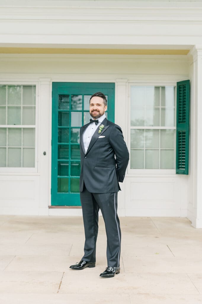 Tom smiles on the front porch of the Hill-Stead Museum while it's raining outside.