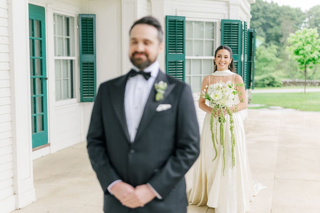 Natalie walks up to Tom from behind for a rainy first look at Hill-Stead. 
