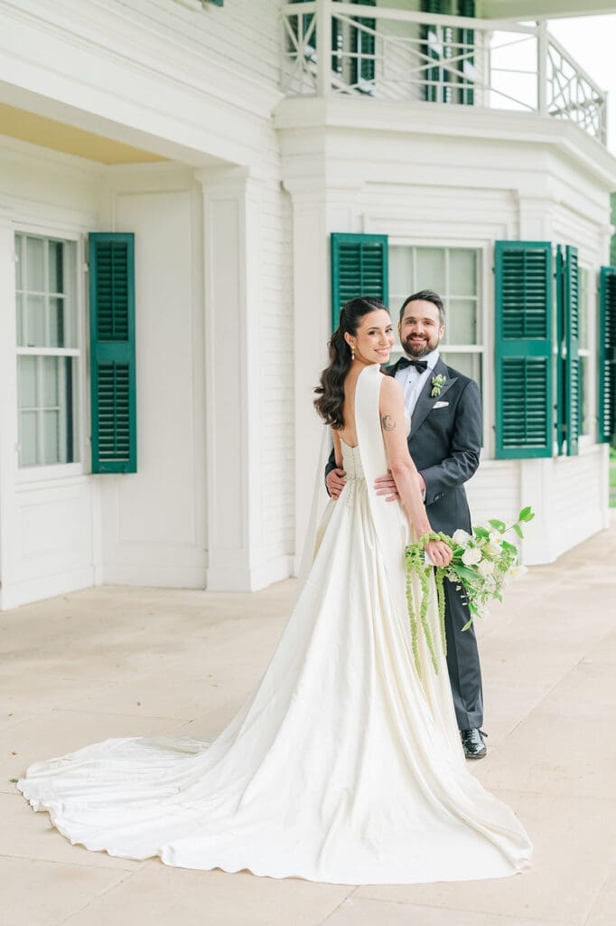 Tom and Natalie pose for a classic wedding portrait on the front porch. 