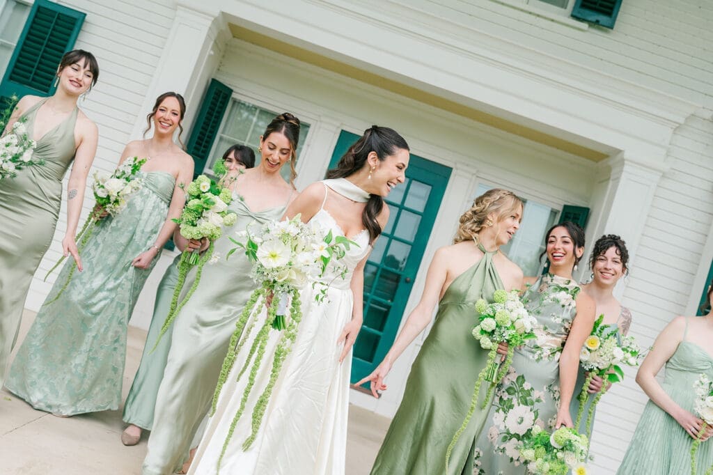 Natalie walks and laughs with her bridesmaids. 