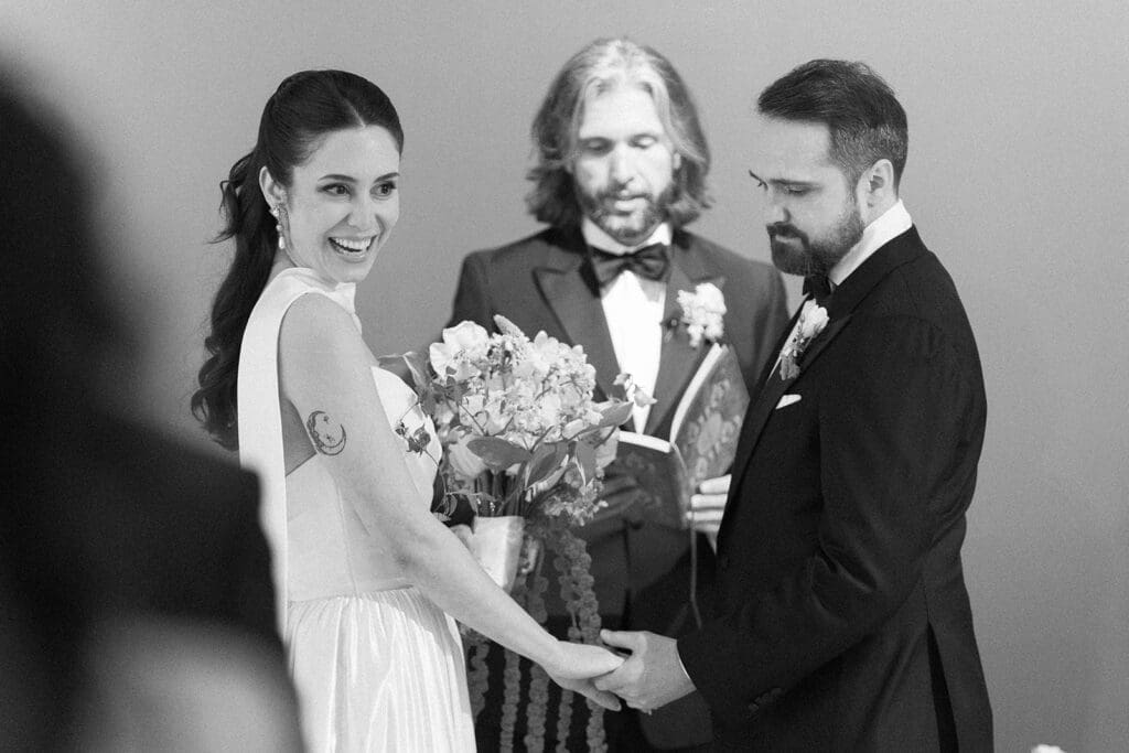 Natalie smiles during their rainy wedding ceremony, which was moved indoors. 