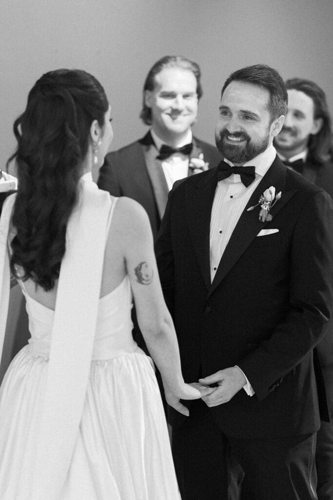 Tom smiles at Natalie during their rainy wedding ceremony, which was moved indoors. 