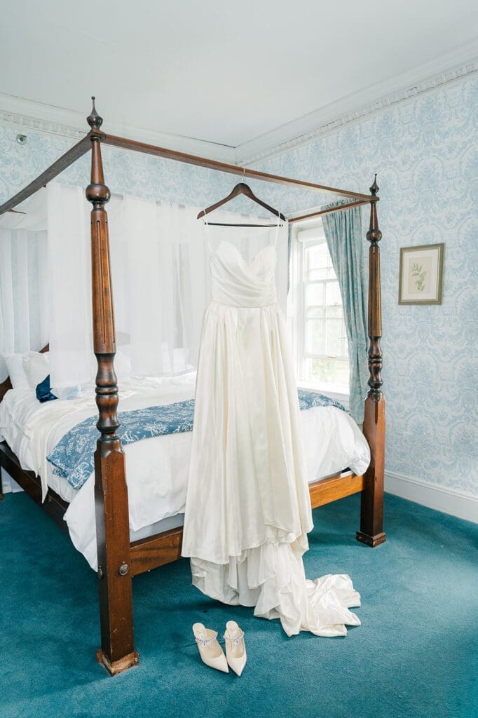 A wedding dress hanging from a bedpost at the Simsbury 1820 Inn. 