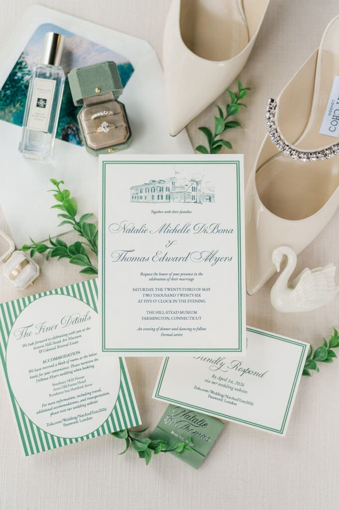 A flat lay of a green and ivory invitation suite for Natalie and Tom. 