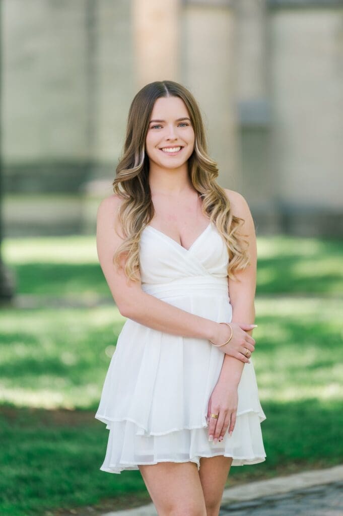 A girl smiling for her Trinity College grad photos 
