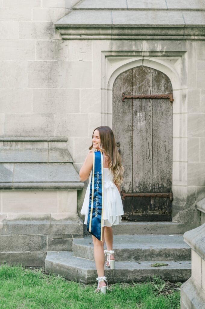 Sophia stands on steps at the Trinity College chapel. 