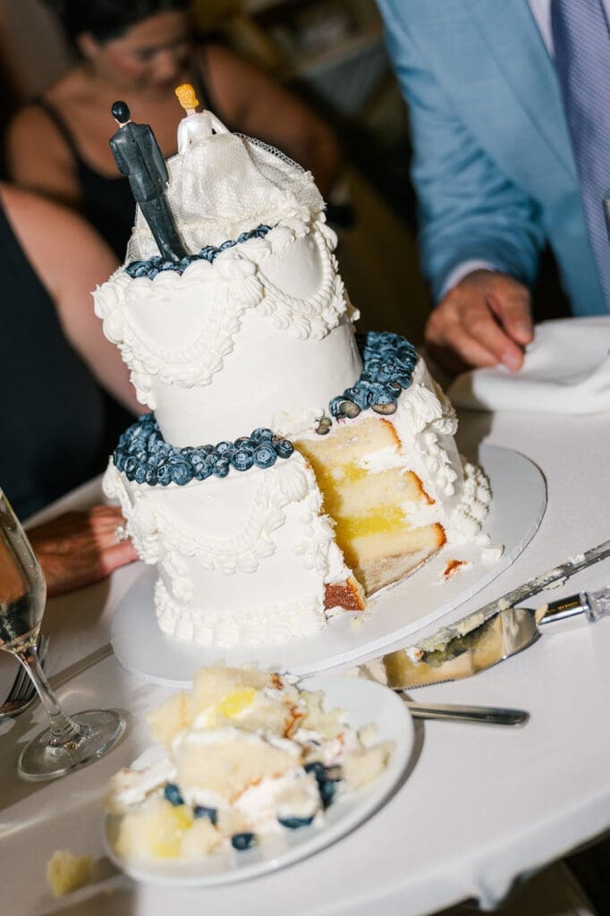 A two tier wedding cake with a vintage cake topper. 