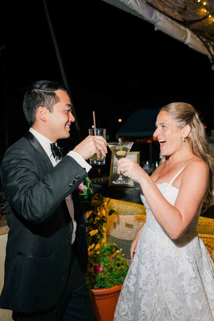 katie and sang cheers their glasses together at their Delamar Greenwich Wedding. 