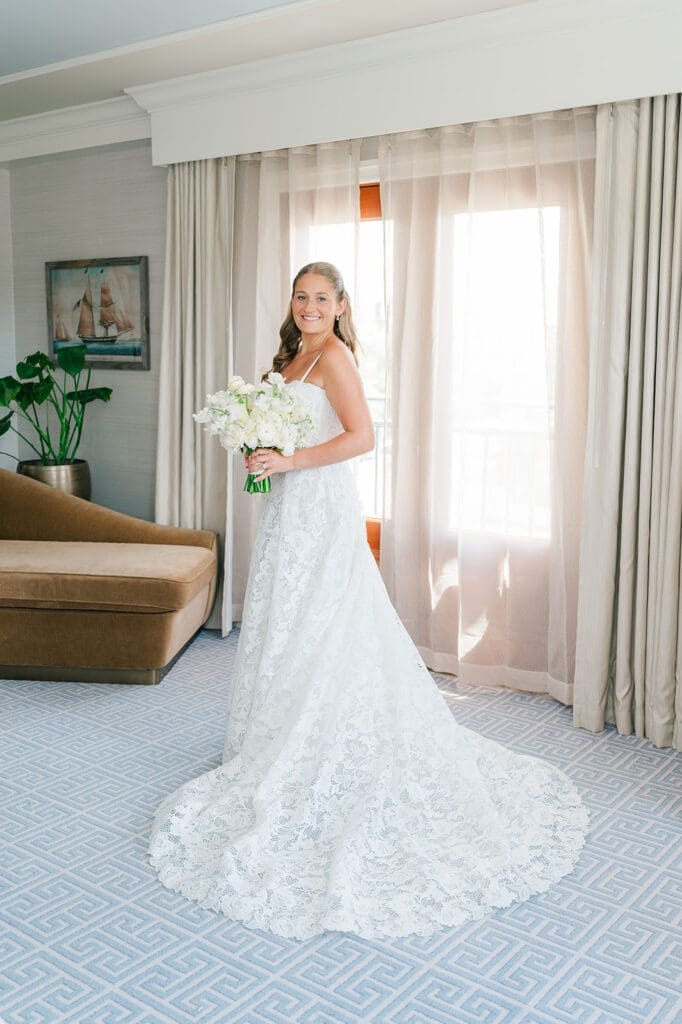 Katie smiles in her wedding dress at Delamar Greenwich Harbor. 