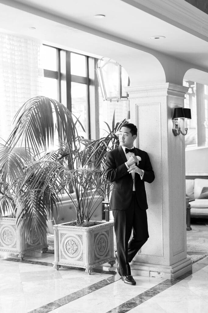 Sang peers out the doorway at Delamar Greenwich in his wedding day attire. 