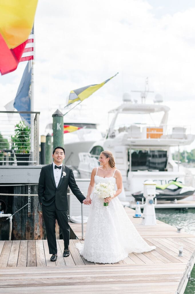 Katie and Sang smile at eachother while they walk at Delamar Greenwich.