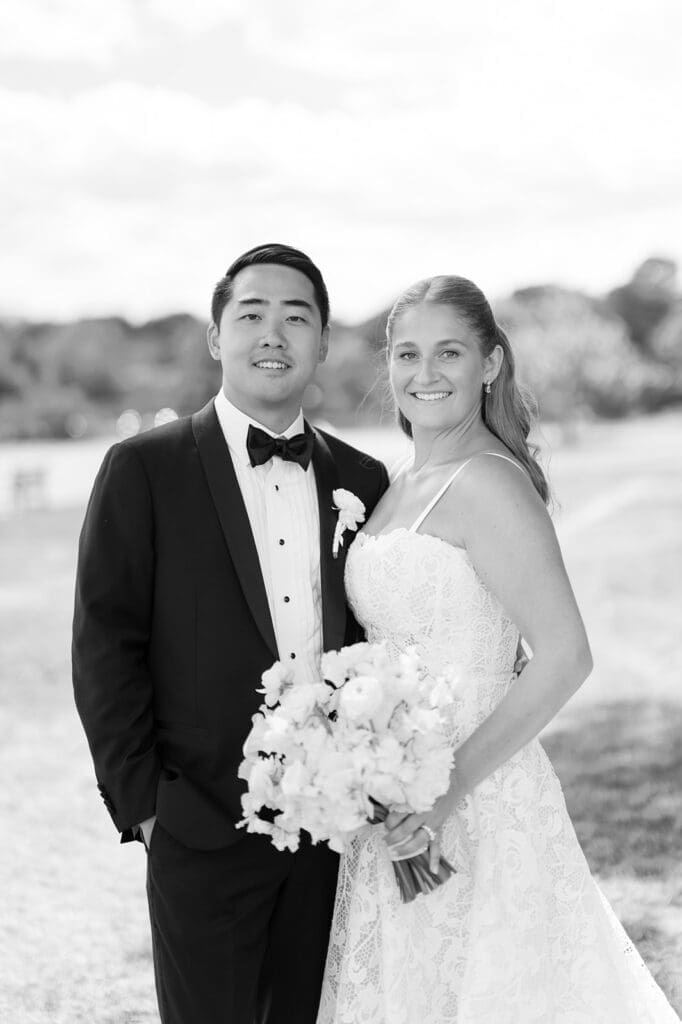 Katie and Sang smile in a classic black and white wedding portrait at Delamar Greenwich.