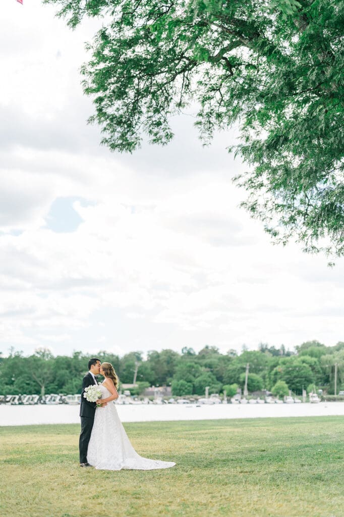 Katie and Sang kiss under a tree in Greenwich. 